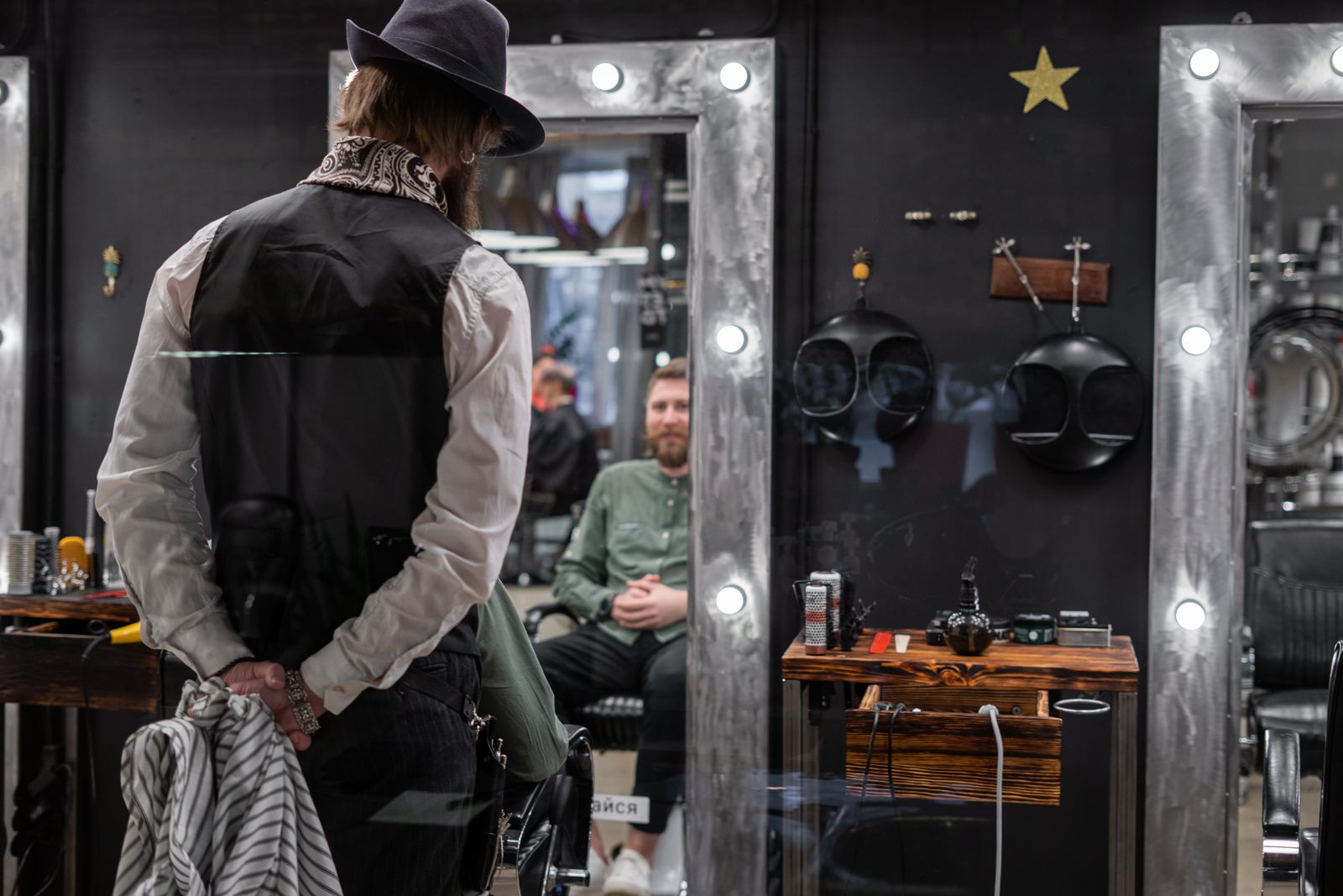 Mirror-lit stations inside Brasslark Barber Club